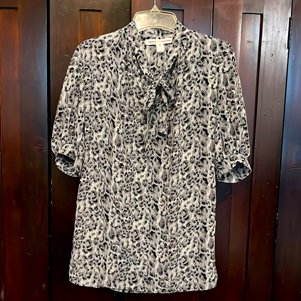 Tunic blouse with puff sleeves, size small, in worn condition.